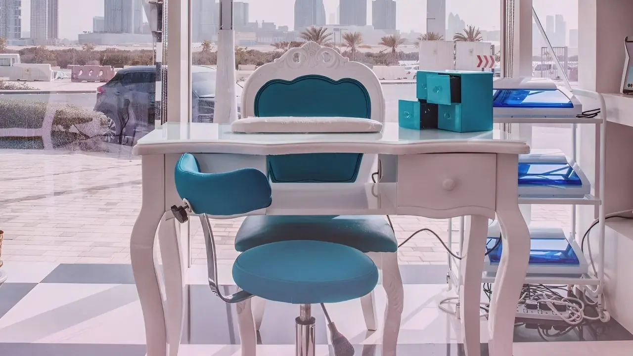 Nail bar with pink walls and teal chairs